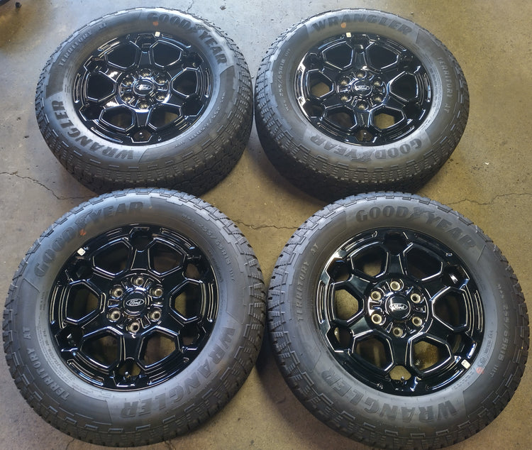 Four Ford Ranger OEM 18-inch gloss black wheels with Goodyear Wrangler Territory AT tires and Ford center caps.
