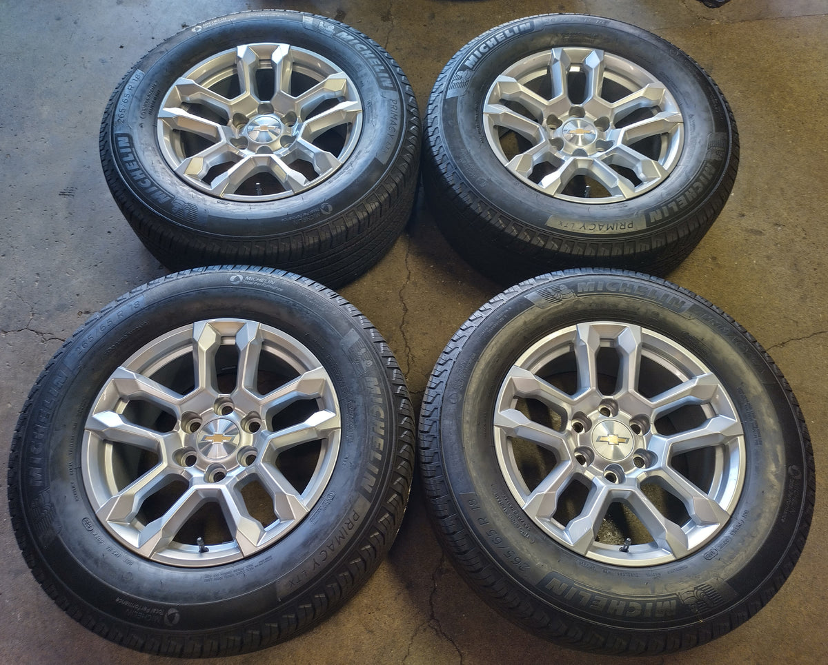 Four Chevrolet OEM 18-inch silver wheels with Michelin Primacy LTX tires and Chevrolet center caps.