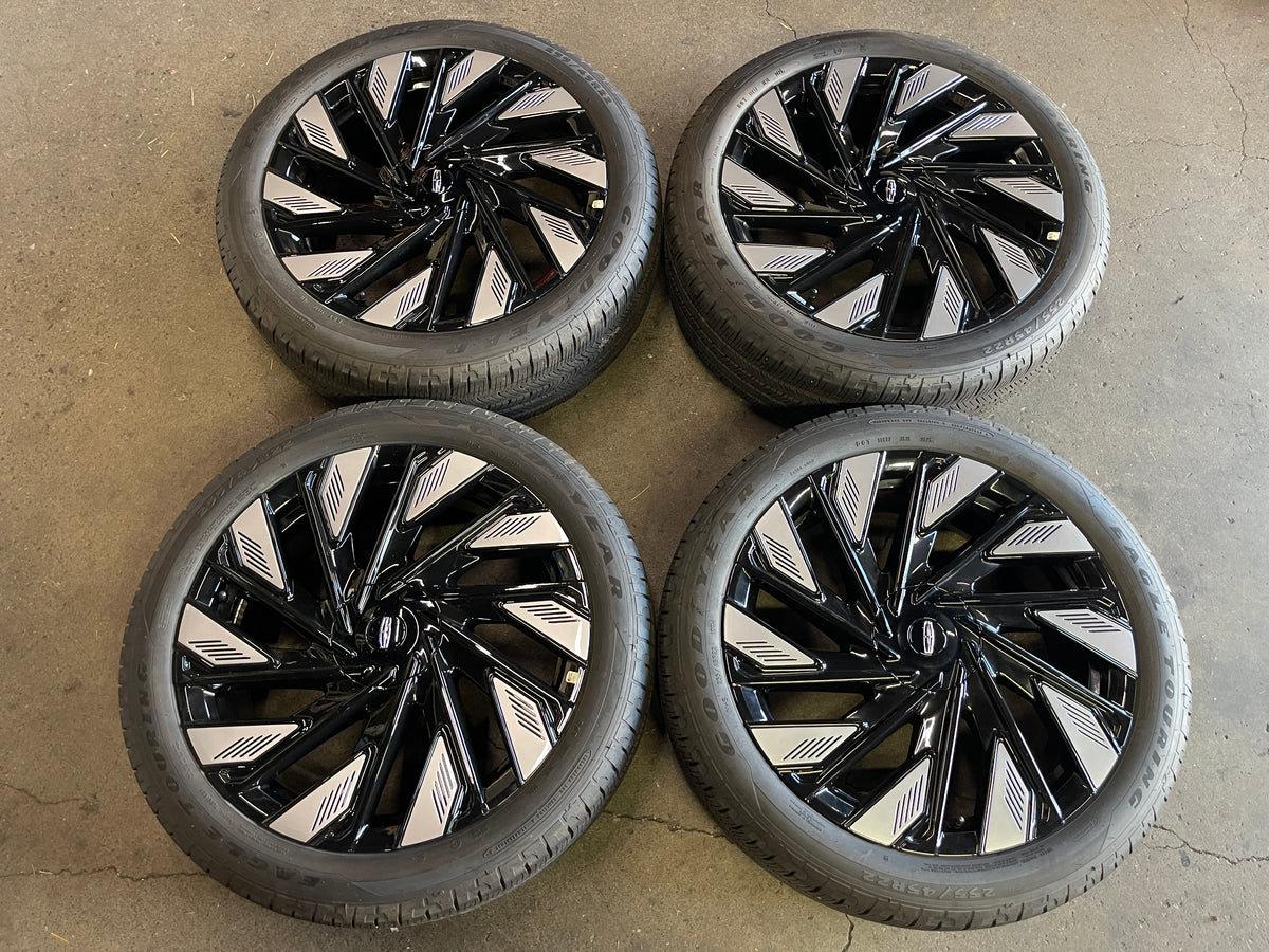 Four black and silver Lincoln Nautilus OEM wheels with mounted Goodyear tires and Lincoln center caps