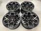 Four Ford F-150 Raptor R OEM wheels in black and gray with beadlock-style rings and Ford center caps.