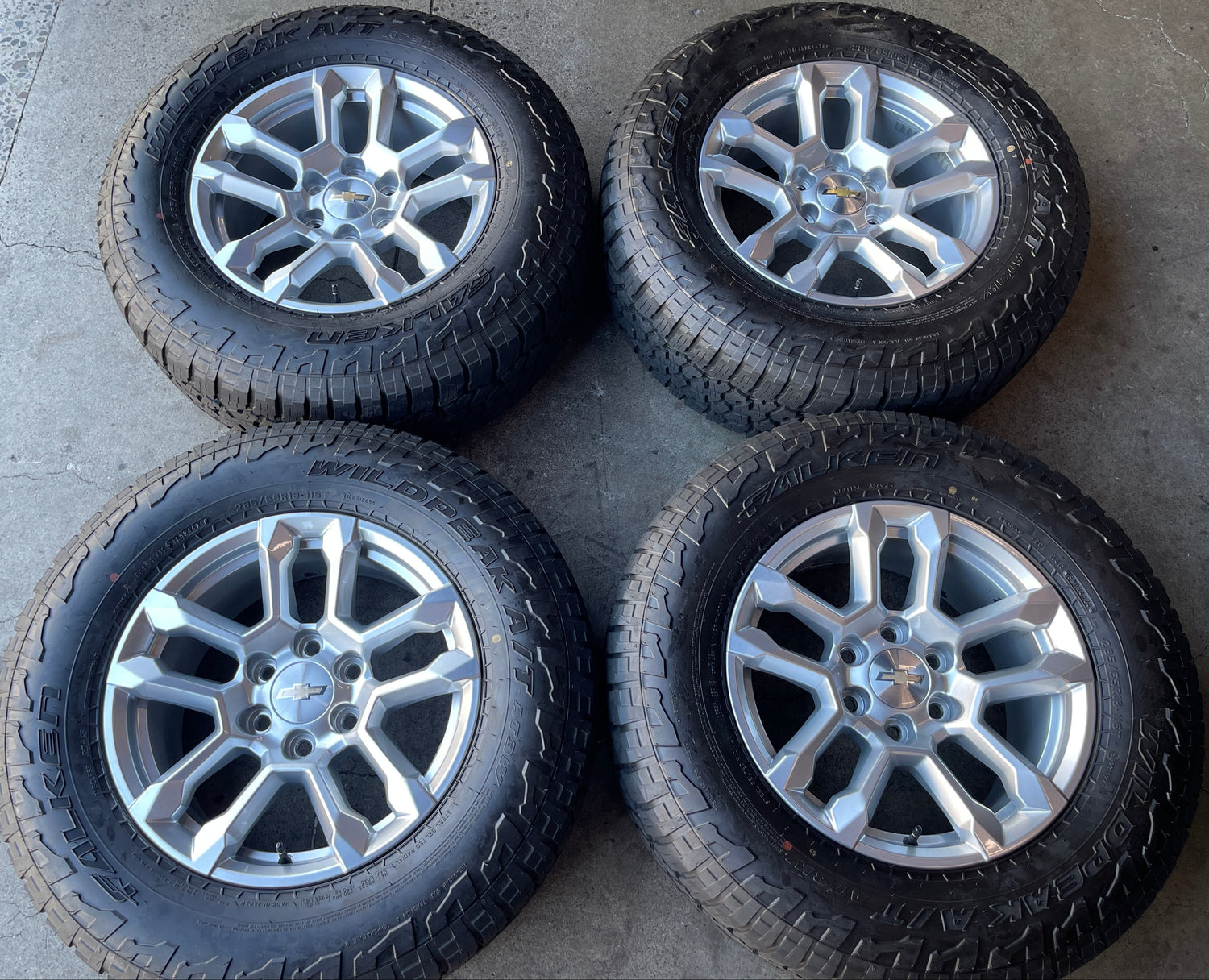 2026 Chevy Silverado 1500 OEM 18" Silver Wheel Rim Tire Set of 4 — Falken Wildpeak A/T3W 285/65R18 | Part# 84775274
